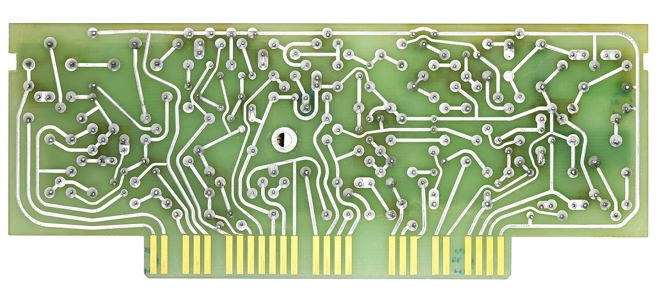 Close view of a green circuit board with gold contact pads